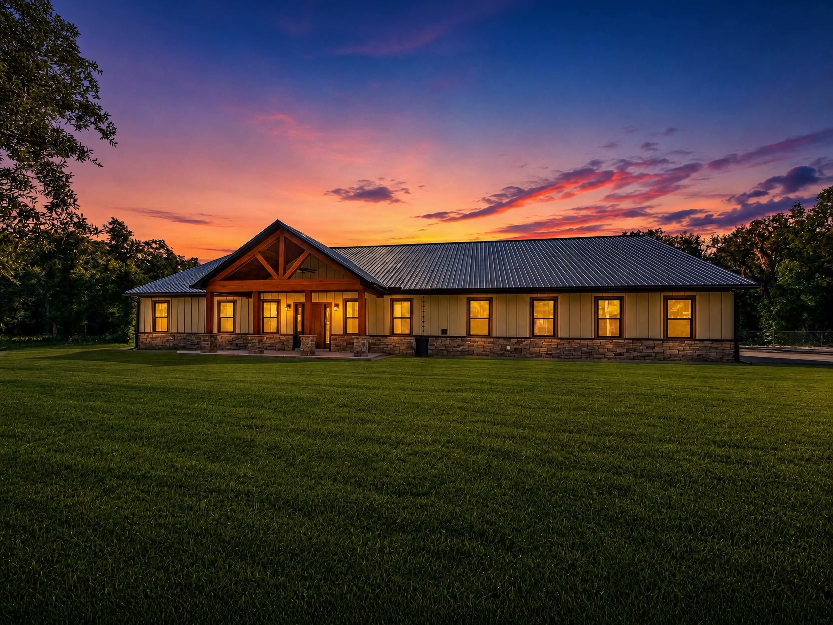 Custom home built by Keystone Custom Builders in Northeast Florida, shown at dusk with warm lit windows